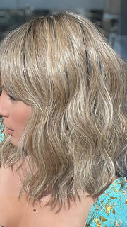 Model is wearing FRANKIE by ESTETICA in color RH12/26RT4 | Light Brown with Fine Golden Blonde Highlights And Dark Roots