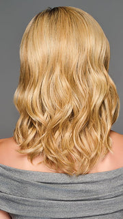 Model is wearing RAISE THE BAR in color GF14-22SS SS WHEAT| Dark Blonde Evenly Blended with Platinum Blonde with Dark Roots