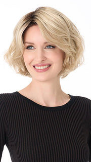 Model is wearing GIA by ENVY in color SILKY BEIGE | Light Platinum Blonde with Dark Brown Roots