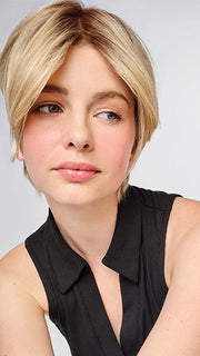 Model is wearing HD 6IN AU NATUREL TOPPER in color SS14/88 ROOTED GOLDEN WHEAT | Dark Blonde Evenly Blended with Pale Blonde Highlights and Dark Roots