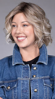 Model is wearing HOUSTON in color MILKSHAKE BLONDE R | A mixture of Light Sandy Brown, Highlighted with Light Ash Blonde with a Hint of Light Platinum Blonde with a Medium Root Color