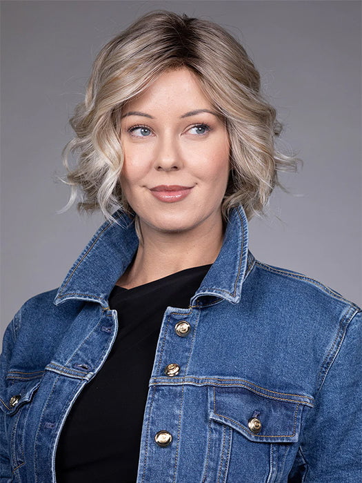 Model is wearing HOUSTON in color MILKSHAKE BLONDE R | A mixture of Light Sandy Brown, Highlighted with Light Ash Blonde with a Hint of Light Platinum Blonde with a Medium Root Color