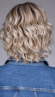 Model is wearing HOUSTON in color MILKSHAKE BLONDE R | A mixture of Light Sandy Brown, Highlighted with Light Ash Blonde with a Hint of Light Platinum Blonde with a Medium Root Color
