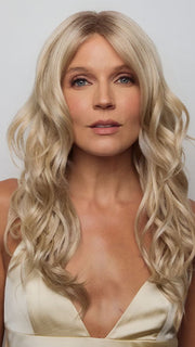 Model is wearing HANA by NORIKO in color Light Ash Blond R | Cream Ash Blonde with ash brown and white-grey roots that blend into a variety of ash blonde tones, including ash pearl blonde, creamy ivory, and pale cream