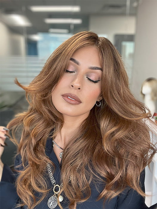 Model is wearing HANA by NORIKO in color Venetian Red R | A beautiful red shade that mixes pale copper, soft mahogany, and warm burnt-toffee cherry tones. The rich chestnut roots add dimension and depth. 