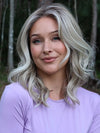 Heather @cjswigs wearing LAGUNA BEACH by BELLE TRESS in color MILKSHAKE BLONDE R | A mixture of Light Sandy Brown, Highlighted with Light Ash Blonde with a Hint of Light Platinum Blonde with a Medium Root Color