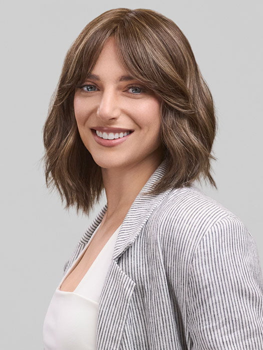 Model is wearing HOLLIE PETITE by JON RENAU in color 8RH14 MOUSSE CAKE | Medium Brown with 33% Medium Natural Blonde Highlights