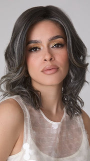 Model is wearing ROHAN by AMORE in color TRUFFLE RIBBON R | Off-Black base with Warm Medium Brown and Silver highlights. The Dark Brown Root creates a naturally dimensional appearance