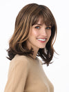 Model is wearing JOLIE by ENVY in color AMARETTO-CREAM | Dark Brown roots with overall Medium Brown base with Honey Blonde highlights