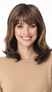 Model is wearing JOLIE by ENVY in color AMARETTO-CREAM | Dark Brown roots with overall Medium Brown base with Honey Blonde highlights