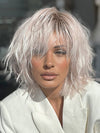 Model is wearing JONES by ESTETICA in color POLARIZING PINK | Icy platinum blonde blended with soft rose and silver undertones. Medium ash brown roots add dimension and depth.