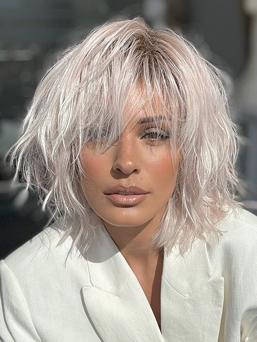 Model is wearing JONES by ESTETICA in color POLARIZING PINK | Icy platinum blonde blended with soft rose and silver undertones. Medium ash brown roots add dimension and depth.