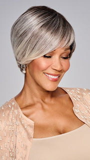 A sleek, asymmetrical haircut with long, side-swept bangs