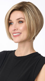 Model is wearing KARI by ENVY in color SPARKLING CHAMPAGNE | Medium Brown roots with overall Strawberry Blonde base and soft Golden Blonde highlights