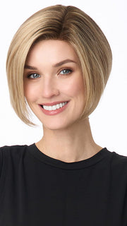 Model is wearing KARI by ENVY in color SPARKLING CHAMPAGNE | Medium Brown roots with overall Strawberry Blonde base and soft Golden Blonde highlights
