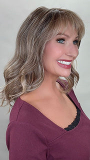 Kim Hammon @letstalkwithkim wearing HEPBURN by BELLE TRESS in color BROWN SUGAR BLONDE-R | A warm, dimensional blend of medium brown and golden blonde highlights with natural-looking darker roots for depth and a sun-kissed finish.