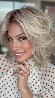 Model is wearing LORYN in color SEA SALT BLOND R | A perfect mixture of cool, icy-blond and warm-dark blond. The rich brown root tone enhances the modern appearance