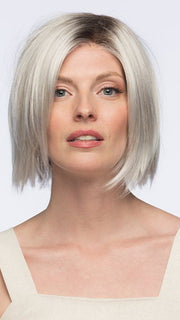 Model is wearing LUMI by Estetica in color SILVERSUN/RT8 | Iced Blonde with Soft Sand and Golden Brown Roots