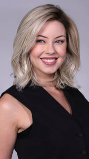 Model is wearing MANHATTAN by BELLETRESS in color CRUSHED-ALMOND-BLONDE-R | A soft Neutral Light Blonde with a Light and Medium Blended Root Color