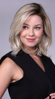 Model is wearing MANHATTAN by BELLETRESS in color CRUSHED-ALMOND-BLONDE-R | A soft Neutral Light Blonde with a Light and Medium Blended Root Color
