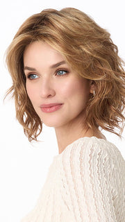 Model is wearing MARSHA by ENVY in color GOLDEN NUTMEG | Medium Brown roots with overall Warm Cinnamon base and Golden Blonde Highlights