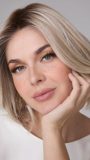 Model is wearing MIRA by AMORE in color SEA SALT BLOND R | A perfect mixture of cool, icy-blond and warm-dark blond. The rich brown root tone enhances the modern appearance.    
