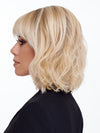 Model is wearing NEW WAVE by TRESSALLURE in color 24/102/R12 | Gold Blonde with Platinum highlights with Gold Brown roots