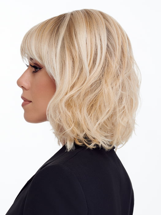 Model is wearing NEW WAVE by TRESSALLURE in color 24/102/R12 | Gold Blonde with Platinum highlights with Gold Brown roots
