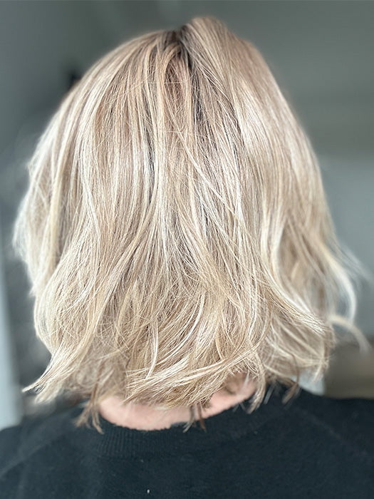 Emily H. @she_sheds_more wearing NEWPORT by BELLE TRESS in color RAW SUGAR BLONDE | A Neutral Light Blonde, Honey Blonde, Pale Gold Blonde, with a base of Light Brown Low Lights featuring a Medium Root Color