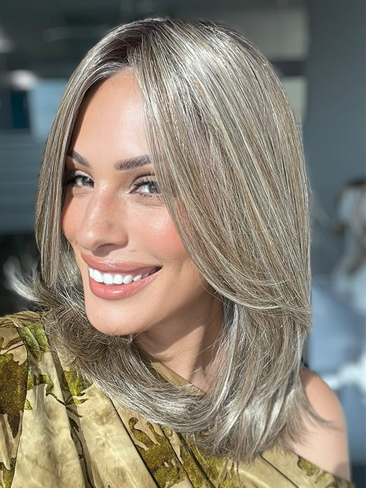 Roxie is wearing OWN THE ROOM LUXURY by GABOR in color GF12-22SS CAPPUCCINO | Light Golden Brown Evenly Blended with Cool Platinum Blonde Highlights with Dark Roots