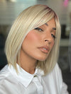 Model is wearing PAIGE by ENVY in color SILKY BEIGE | Light Platinum Blonde with Dark Brown Roots