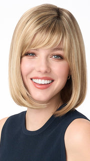 Model is wearing PAIGE PETITE by ENVY in color SPARKLING CHAMPAGNE | Medium Brown roots with overall Strawberry Blonde base and soft Golden Blonde highlights