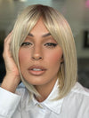 Model is wearing PAIGE by ENVY in color SILKY BEIGE | Light Platinum Blonde with Dark Brown Roots