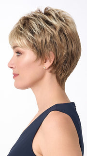 Model is wearing PENELOPE by ENVY in color SPARKLING CHAMPAGNE | Medium Brown roots with overall Strawberry Blonde base and soft Golden Blonde highlights