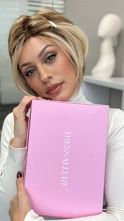 Model wearing POISED by TRESSALLURE in color EL12/22/R8 | Light Golden Brown Evenly Blended with Platinum Blonde Highlights with Medium Brown Roots (styled; clips not included)