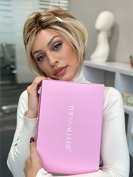 Model wearing POISED by TRESSALLURE in color EL12/22/R8 | Light Golden Brown Evenly Blended with Platinum Blonde Highlights with Medium Brown Roots (styled; clips not included)