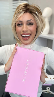 Model wearing POISED by TRESSALLURE in color EL12/22/R8 | Light Golden Brown Evenly Blended with Platinum Blonde Highlights with Medium Brown Roots (styled; clips not included)
