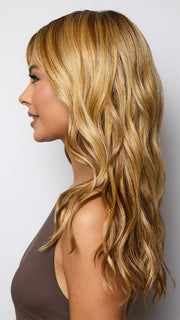 Model is wearing POSH WAVEZ in Bronzed Honey-R  | A perfect blend of rich, warm golden blond and medium chocolate brown tones, complemented by a dark chocolate root that adds a luxurious, dimensional effect.