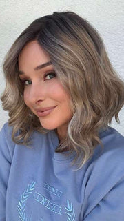 Heather @cjswigs wearing EMMA by ENVY BY ALAN EATON in color SPARKLING-CHAMPAGNE | Medium Brown roots with overall Strawberry Blonde base and soft Golden Blonde highlights
