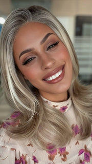 Roxie is wearing MIRANDA by JON RENAU in 101/88/27S8 CATALINA BLONDE | Pale blonde with Pure White Natural Violet halo highlights, shaded medium brown