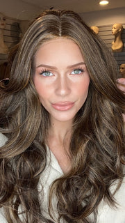 Madeline wearing LONG TOUSLED WAVES by HAIRDO in R829S+ GLAZED HAZELNUT | Rich Medium Brown with Ginger Highlights on Top
