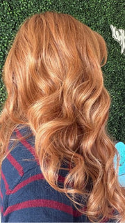 Carly wearing WITHERSPOON by BELLETRESS in MIXED BERRY R | A bold, berry-inspired red with deep auburn tones and soft rooting for a natural regrowth effect. 