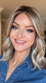 Sandy wearing BRADSHAW by BELLETRESS in BUTTERCAKE BLONDE-R | A neutral-warm blonde blend featuring light brown, ash, and lightest blonde tones with natural-looking darker roots for added depth and realism.