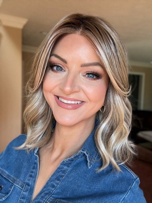 Sandy wearing BRADSHAW by BELLETRESS in BUTTERCAKE BLONDE-R | A neutral-warm blonde blend featuring light brown, ash, and lightest blonde tones with natural-looking darker roots for added depth and realism.