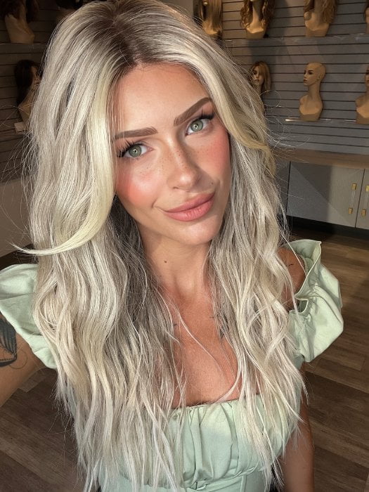 Madeline wearing ROXIE by RENE OF PARIS in BILLIONAIRE-BLOND | A chic, sophisticated shade with a rich mocha root melting into beige, ash, and cream blond tones. Face-framing cream and white blond highlights add a refined, upscale finish.