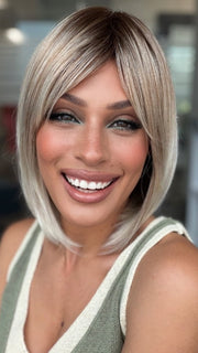 Roxie wearing ALVA by NORIKO in MELTED-MARSHMALLOW | Subtly Warm Dark Sandy Blonde Blend with Medium Brown Roots and Light Ash Blonde Tips and Highlights