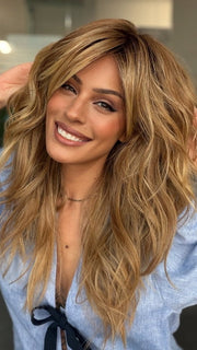 Roxie is wearing CALIFORNIA BEACH WAVES by TRESSALLURE in 14/26/R10 | Red Blonde with Gold Blonde highlights and Light Brown roots