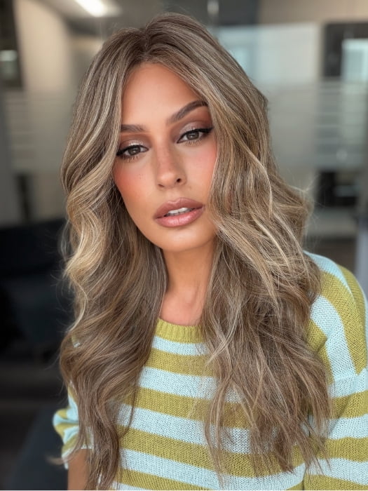 Roxie wearing KATNISS by BELLETRESS in BROWN SUGAR BLONDE-R | A warm, dimensional blend of medium brown and golden blonde highlights with natural-looking darker roots for depth and a sun-kissed finish.