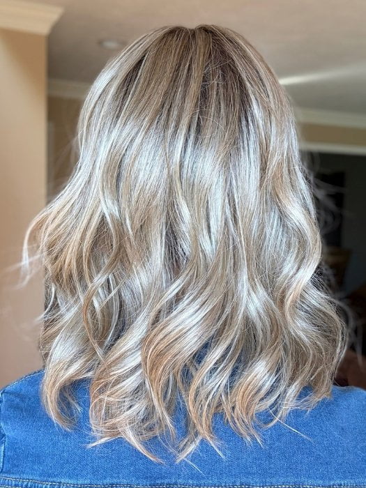 Sandy wearing BRADSHAW by BELLETRESS in BUTTERCAKE BLONDE-R | A neutral-warm blonde blend featuring light brown, ash, and lightest blonde tones with natural-looking darker roots for added depth and realism.