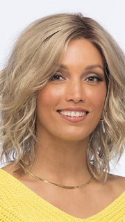 This synthetic wig has subtle layers and free-flowing waves for a cute shoulder-length hairstyle